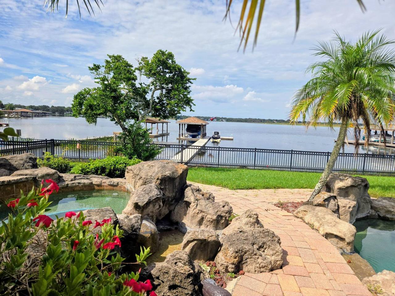 Lakefront pool with rock landscaping before renovation
